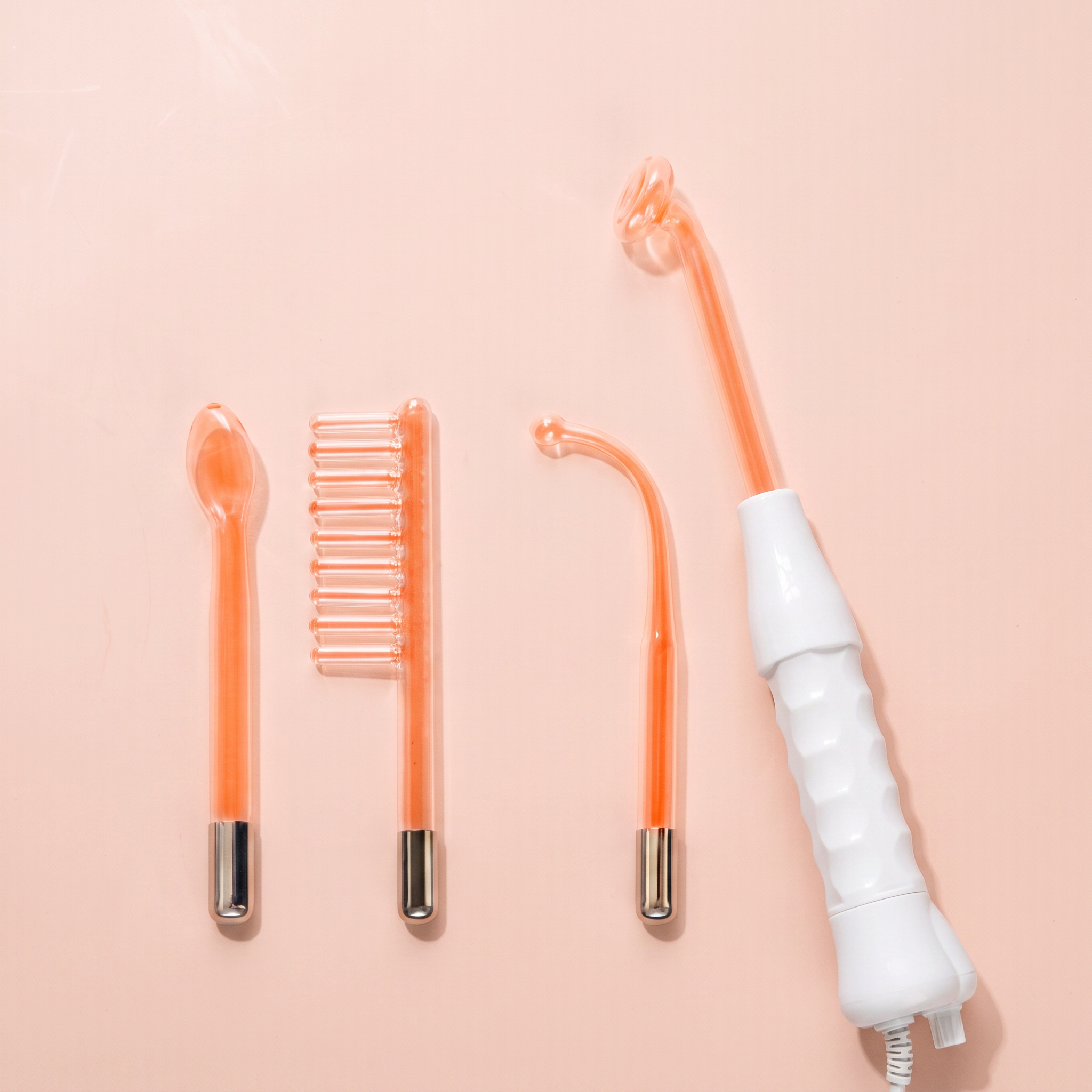 High-Frequency Facial Wand (4-Piece Electrode Kit) — peach editorial product photo