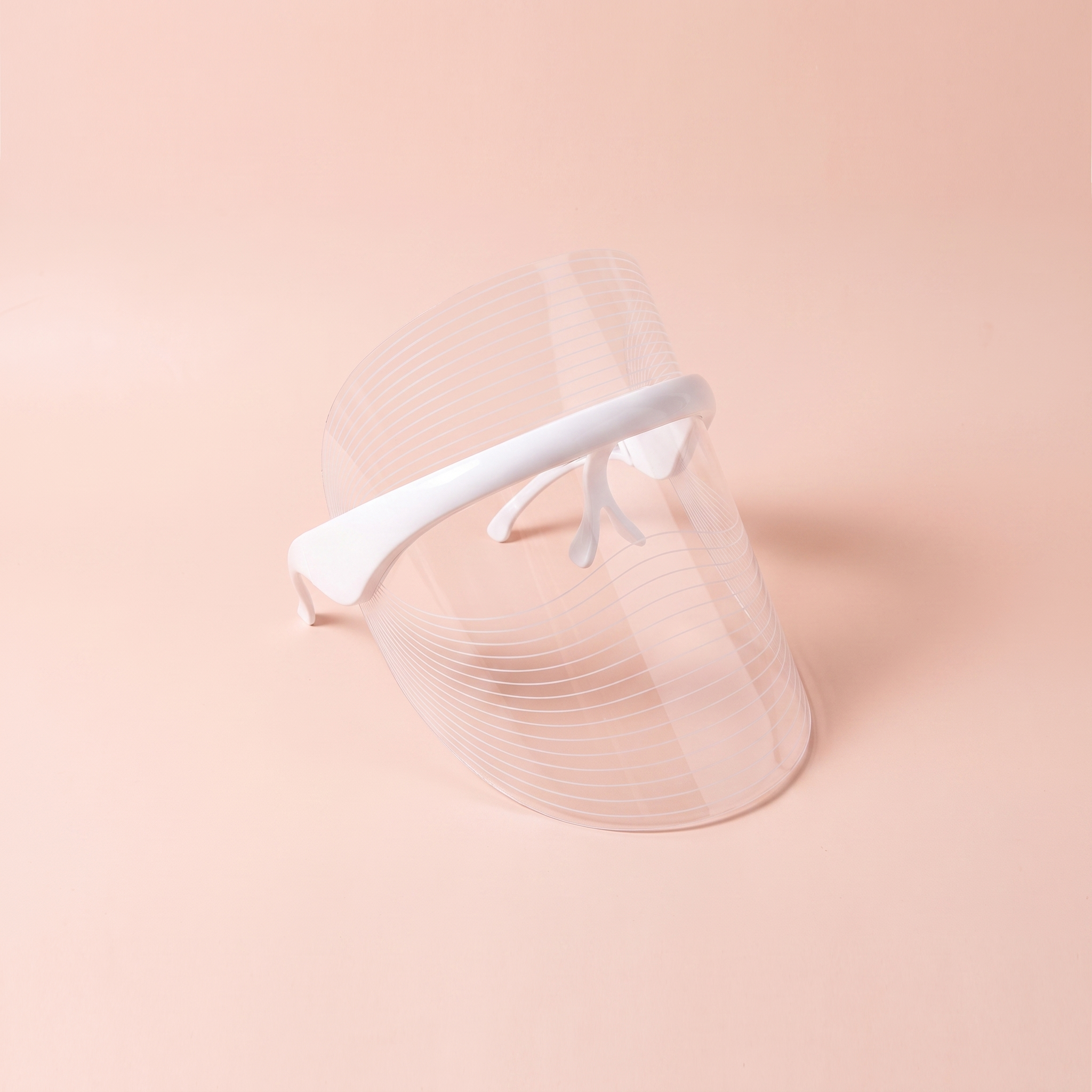7-Colour LED Red-Light Therapy Face Mask — peach editorial product photo