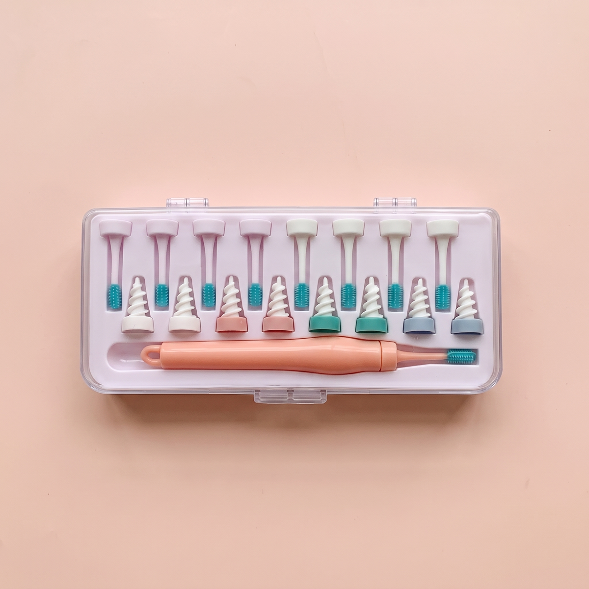 Spiral Ear Wax Remover — peach editorial product photo