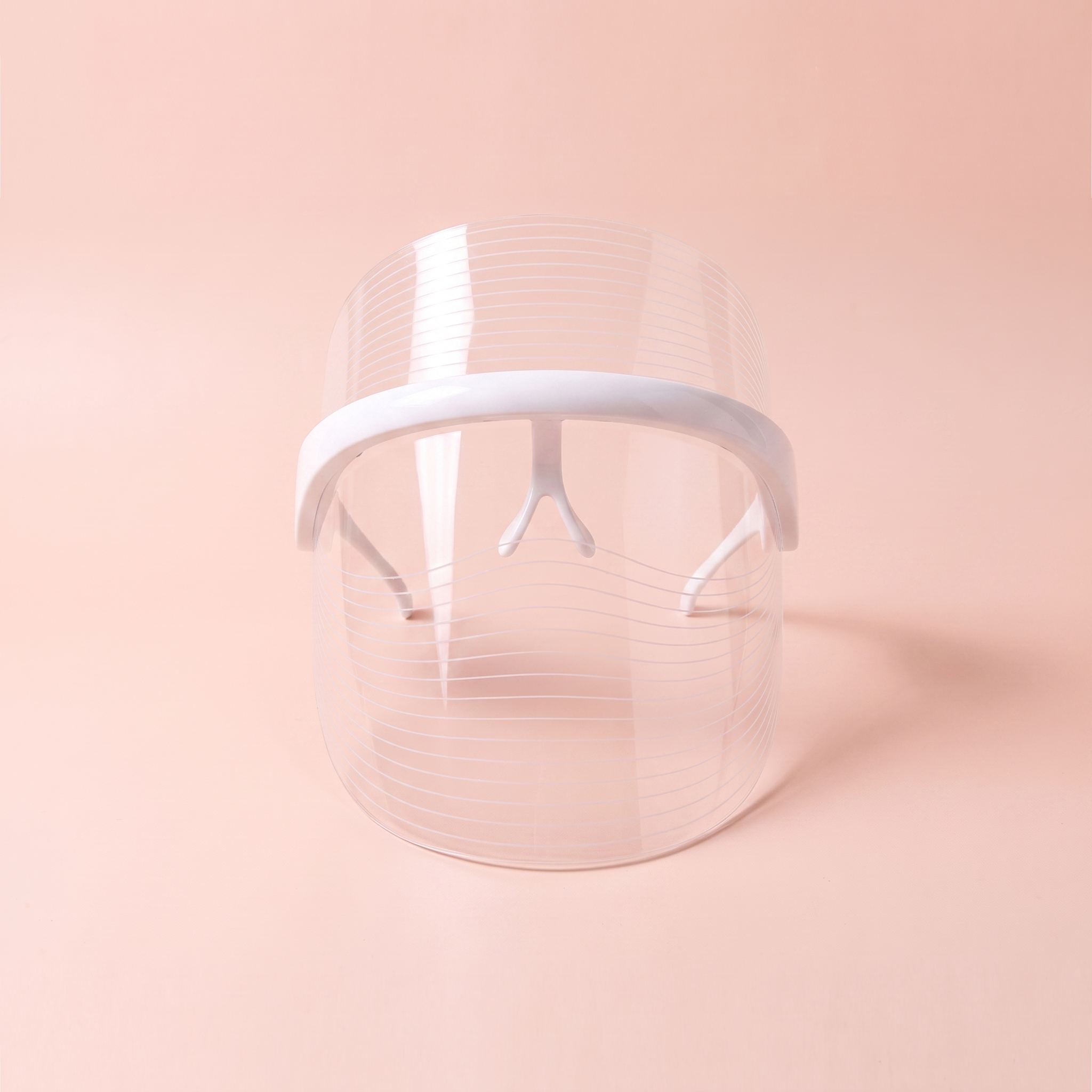 7-Colour LED face mask — front-on view on soft peach background