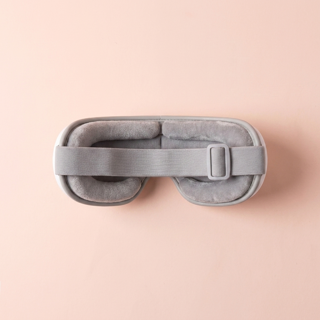 Heated eye massager — folded flat top-down view showing eye cushions