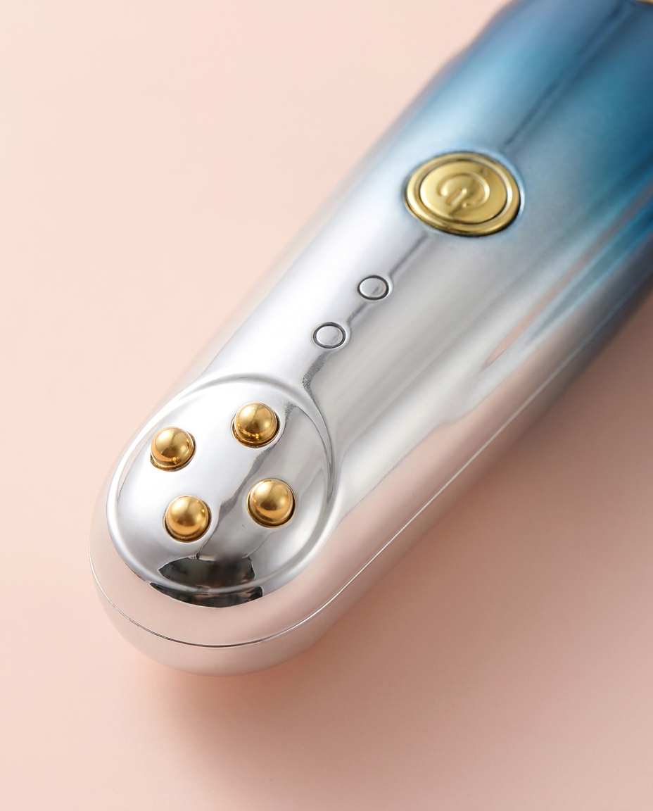 RF Radio-Frequency Eye & Anti-Wrinkle Massager — close-up of warming massage head on peach background