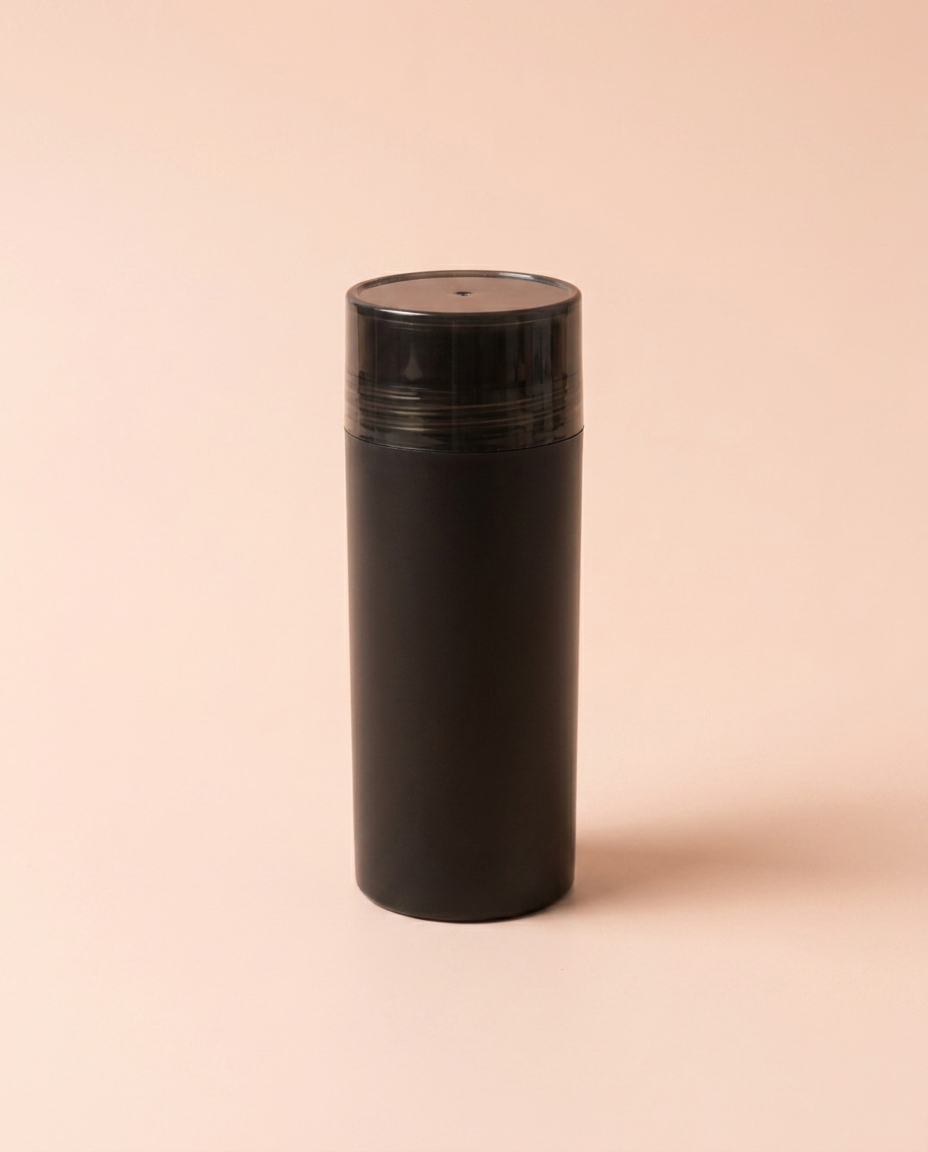 Keratin hair building fibers — front three-quarter view on peach background