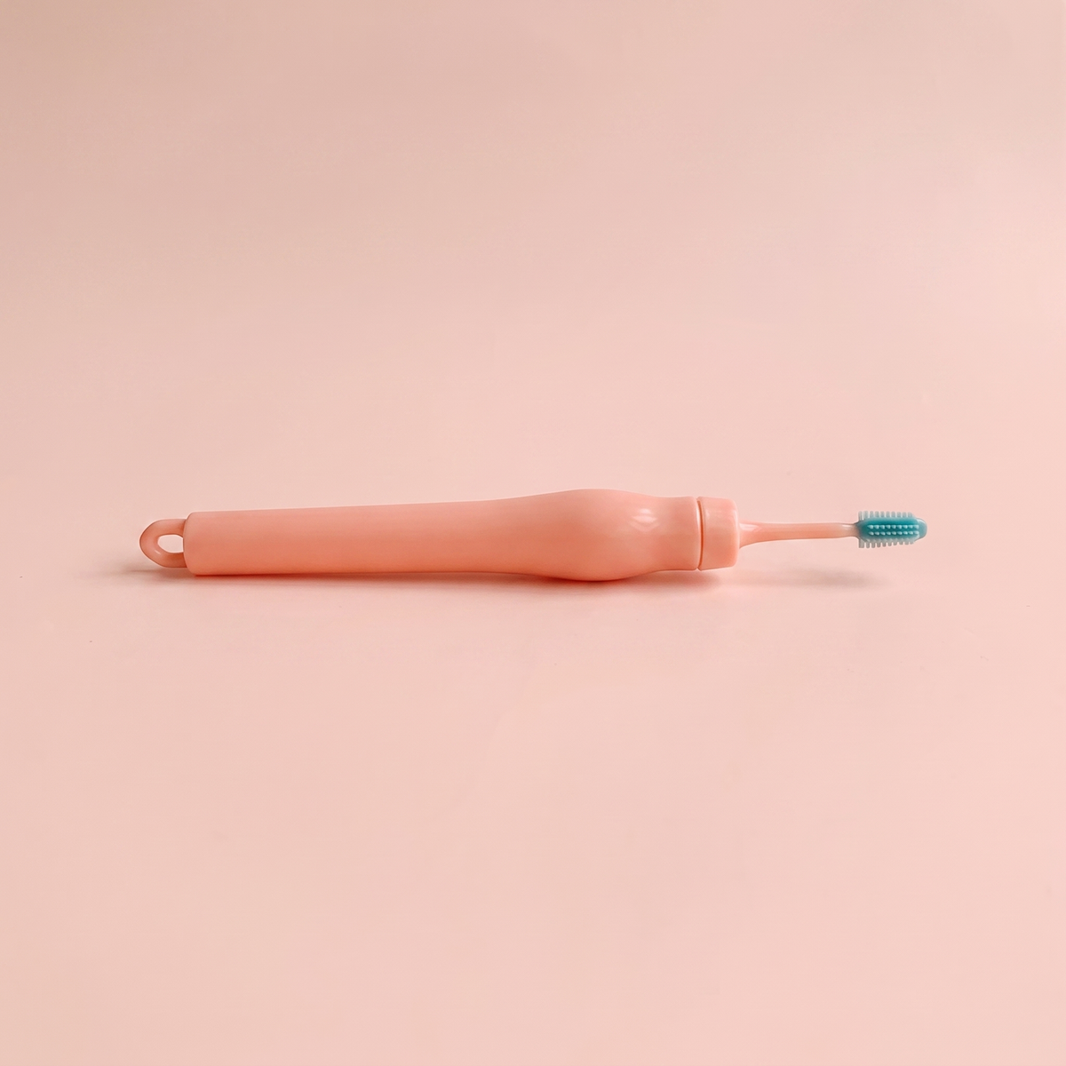 Spiral Ear Wax Remover — side profile view of the handle on peach background