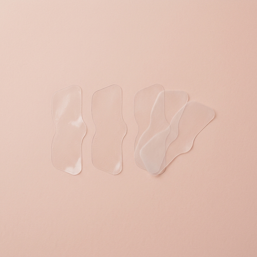 Blackhead nose strips flat-lay on blush background
